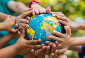 Mani di bambini su mappamondo